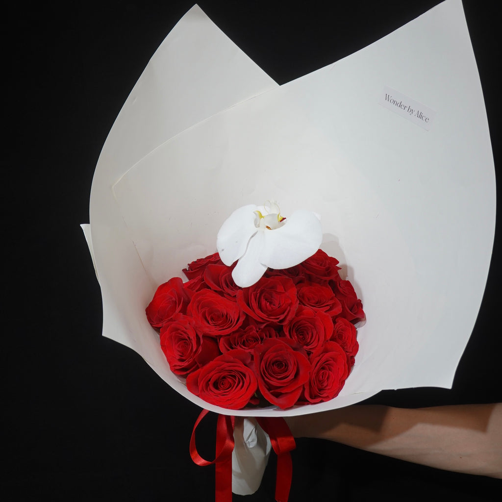 Red rose bouquet with a single white orchid by Wonder by Alice, Canberra